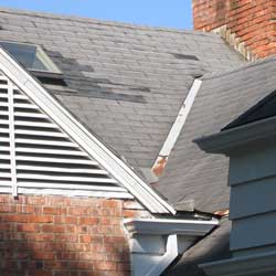 image of roof and shingle damage found in an inspection of a million dollar home